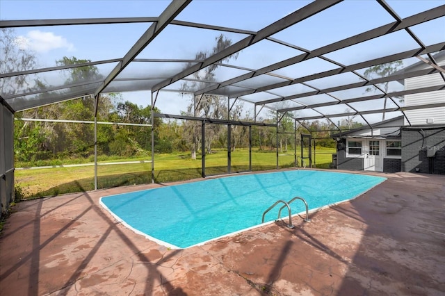 view of pool with a yard, glass enclosure, and a patio area