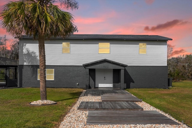 view of front facade featuring a yard and a wooden deck