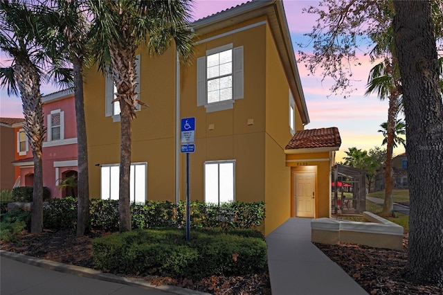 view of outdoor building at dusk