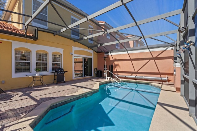 view of swimming pool with a patio, grilling area, and a lanai