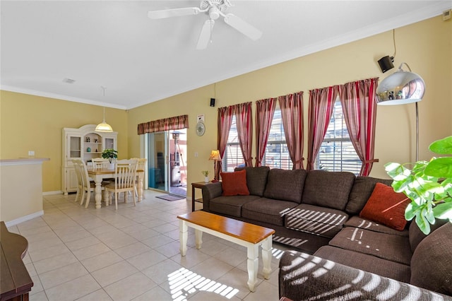 tiled living room with ceiling fan and ornamental molding