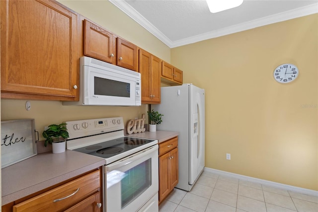 kitchen with a textured ceiling, crown molding, light tile patterned floors, and white appliances