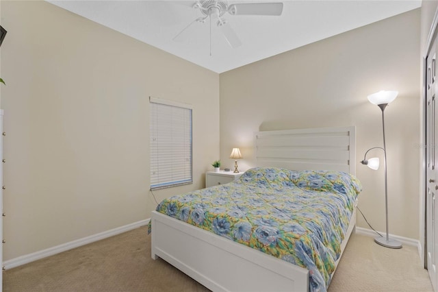 bedroom featuring light colored carpet and ceiling fan