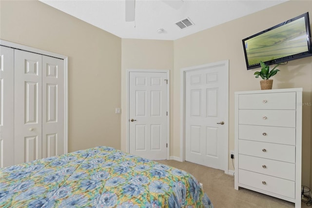 carpeted bedroom with a closet and ceiling fan