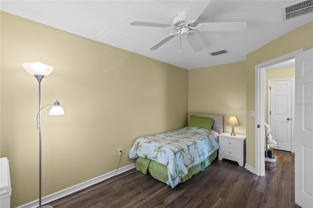 bedroom with ceiling fan and dark hardwood / wood-style flooring