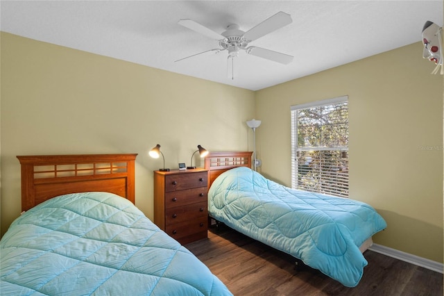 bedroom with ceiling fan and dark hardwood / wood-style floors