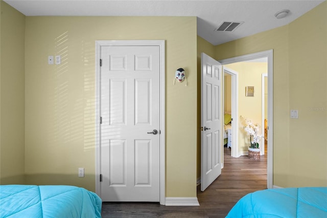 bedroom featuring dark wood-type flooring