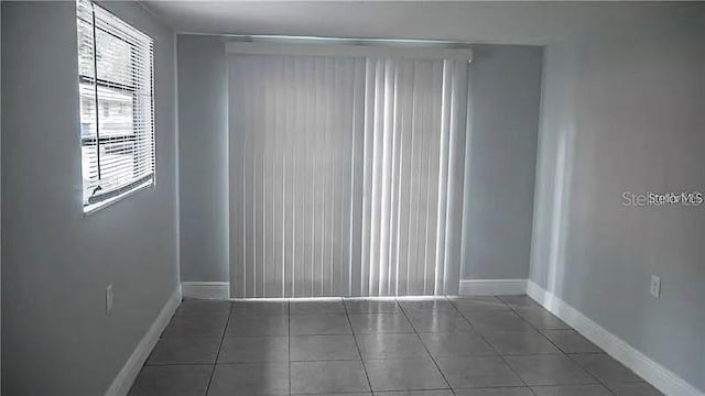 empty room featuring dark tile patterned flooring