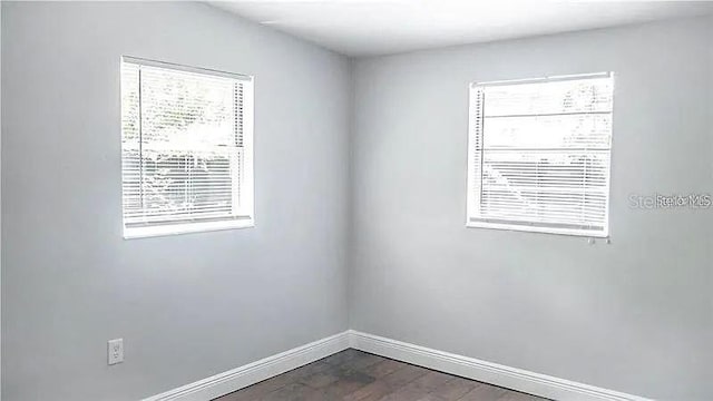 empty room with dark wood-type flooring