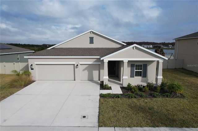 view of front of home featuring a front lawn, covered porch, and a garage