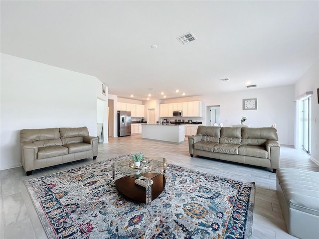 living room with light hardwood / wood-style floors