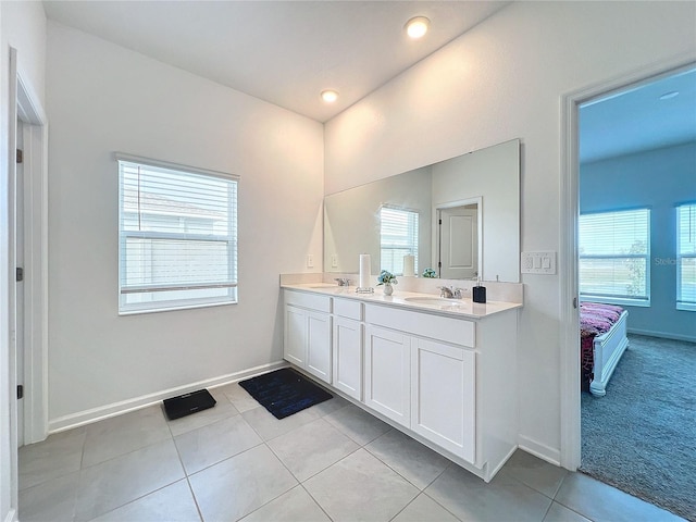 bathroom with plenty of natural light, vanity, and tile patterned flooring