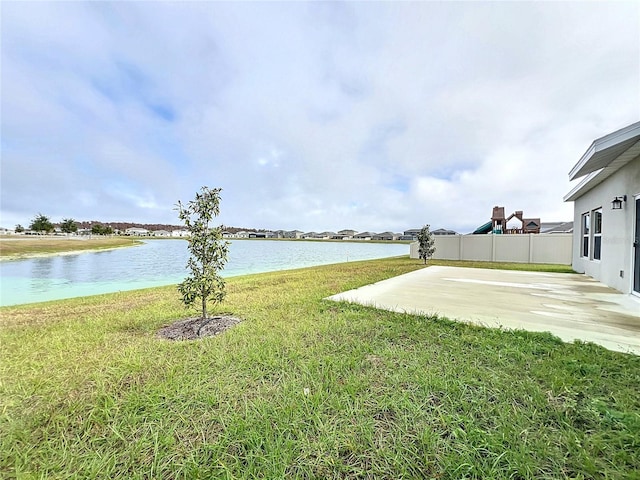 view of yard with a water view and a patio area