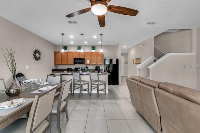 tiled dining area featuring ceiling fan