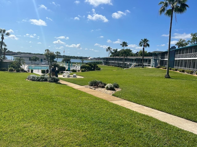 view of home's community with a yard and a water view