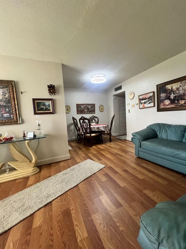 living room with hardwood / wood-style floors and a textured ceiling