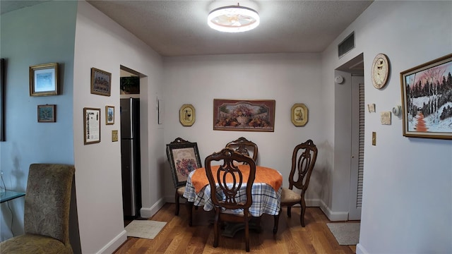 1600 W Lake Parker Dr Unit B23, Lakeland, FL 33805 - dining area with wood finished floors and a textured ceiling