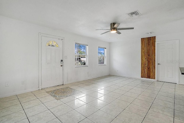 entryway featuring ceiling fan and a textured ceiling