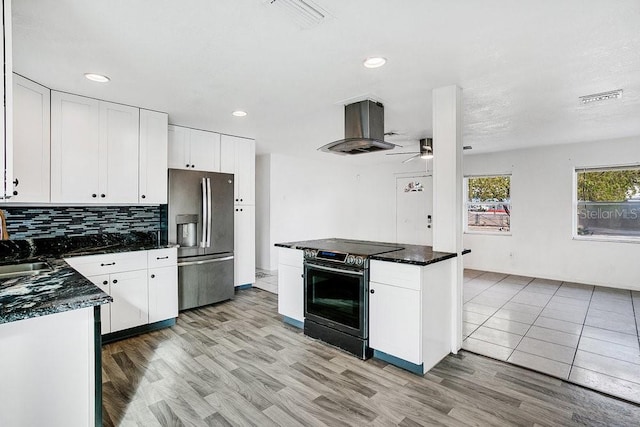 kitchen featuring stainless steel fridge, range with electric cooktop, island range hood, ceiling fan, and white cabinets