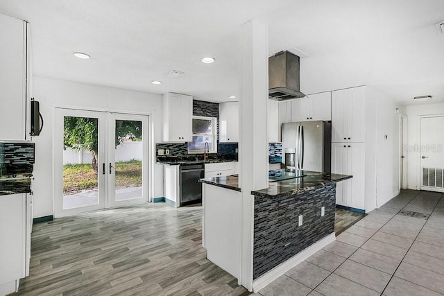 kitchen featuring french doors, extractor fan, black appliances, light hardwood / wood-style floors, and white cabinetry