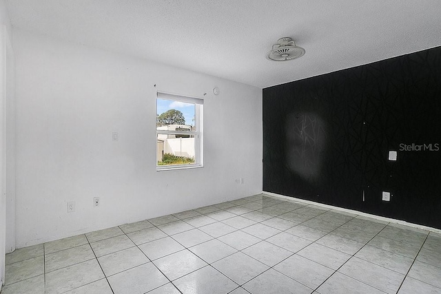 spare room featuring a textured ceiling