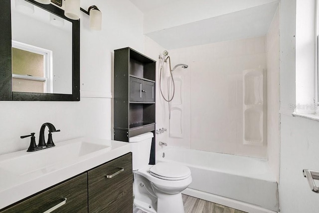 full bathroom with hardwood / wood-style floors, vanity, shower / bath combination, and toilet