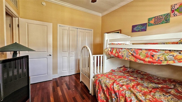 bedroom featuring ceiling fan, a closet, dark wood-type flooring, and ornamental molding