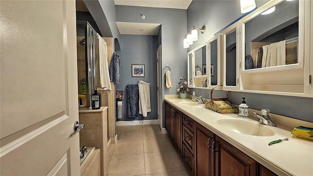 bathroom featuring curtained shower, tile patterned flooring, and vanity