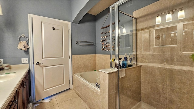 bathroom featuring tile patterned flooring, vanity, and independent shower and bath