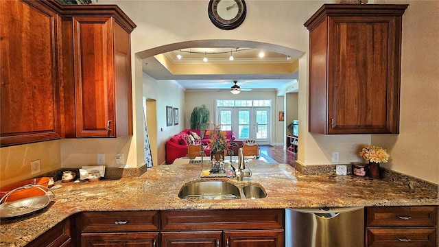 kitchen with ceiling fan, french doors, sink, a raised ceiling, and ornamental molding