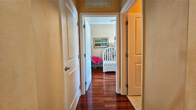 corridor featuring dark hardwood / wood-style floors and ornamental molding