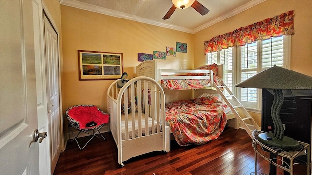 bedroom featuring a closet, ceiling fan, crown molding, and dark hardwood / wood-style floors