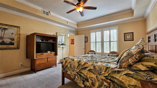 carpeted bedroom with a raised ceiling, ceiling fan, a textured ceiling, and ornamental molding