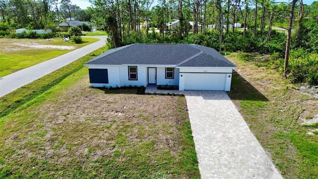 view of front facade featuring a garage and a front lawn