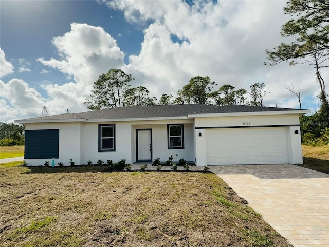 ranch-style home with a front yard and a garage