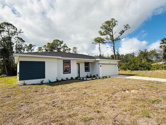 single story home with a garage and a front yard