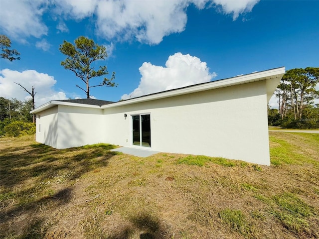 back of house with a yard