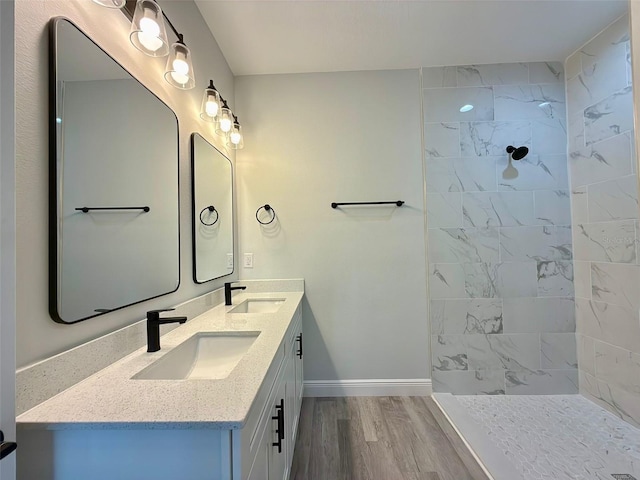 bathroom with vanity, hardwood / wood-style flooring, and walk in shower