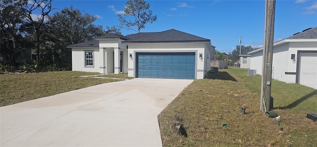 view of front of property with cooling unit, a front yard, and a garage