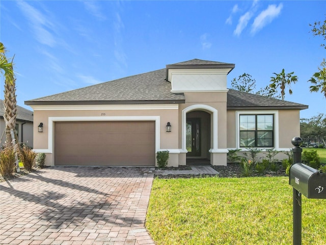 view of front facade featuring a garage and a front lawn