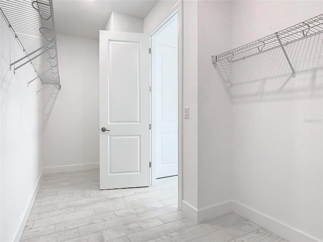 spacious closet featuring light hardwood / wood-style floors