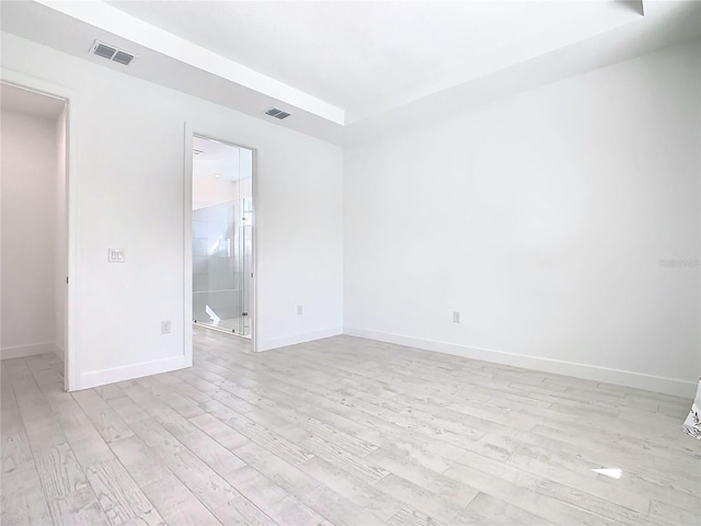 unfurnished room with light wood-type flooring