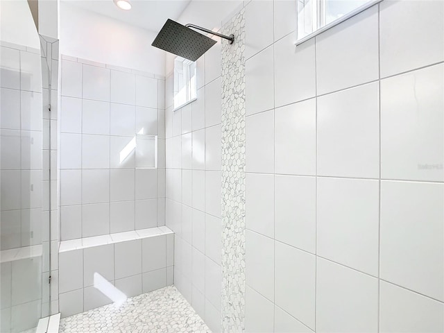 bathroom with tiled shower