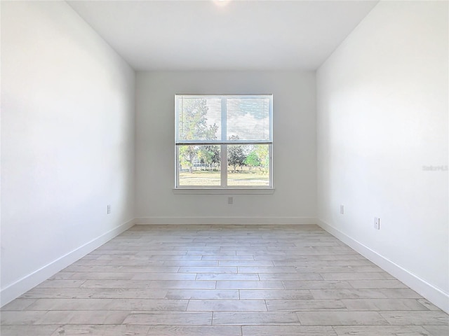 unfurnished room with light hardwood / wood-style flooring