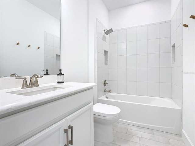 full bathroom with vanity, toilet, and tiled shower / bath combo