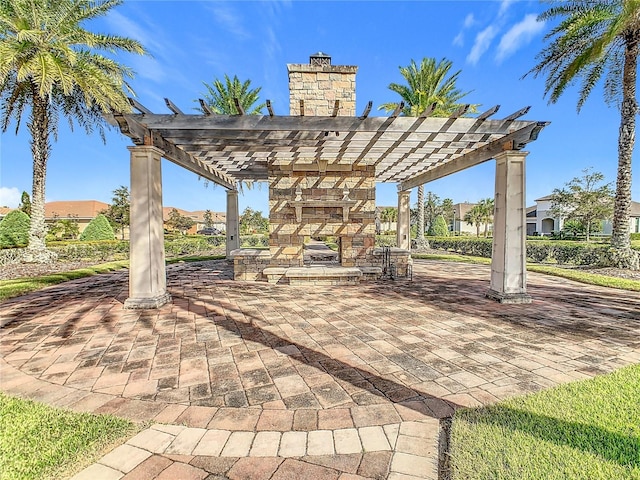 view of patio / terrace with an outdoor stone fireplace and a pergola