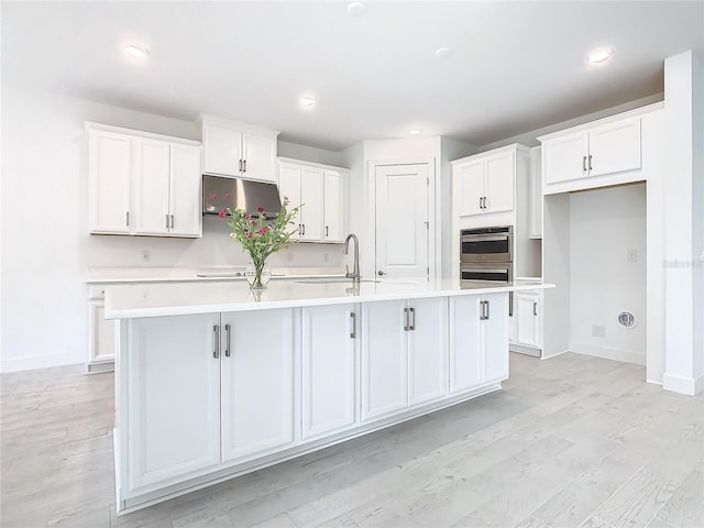 195 Casavista Dr, Kissimmee, FL 34759 - kitchen with a sink, white cabinetry, light countertops, and a large island