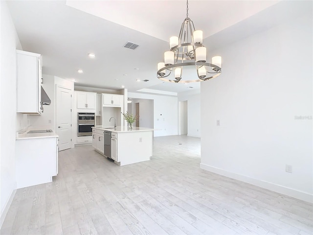 195 Casavista Dr, Kissimmee, FL 34759 - kitchen featuring a sink, wall chimney range hood, open floor plan, a notable chandelier, and appliances with stainless steel finishes