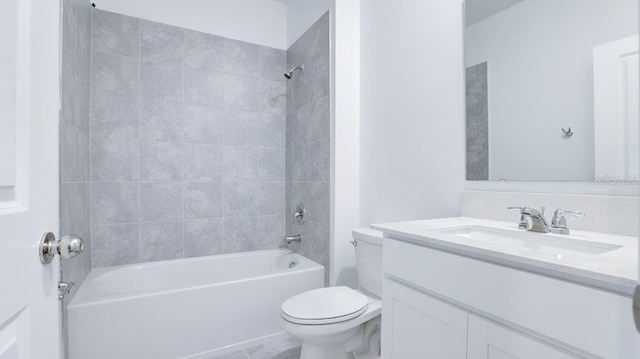 full bathroom featuring vanity, tiled shower / bath combo, and toilet