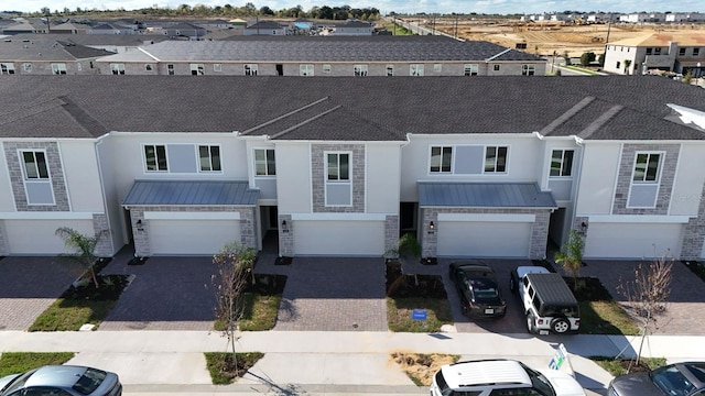 townhome / multi-family property featuring a garage